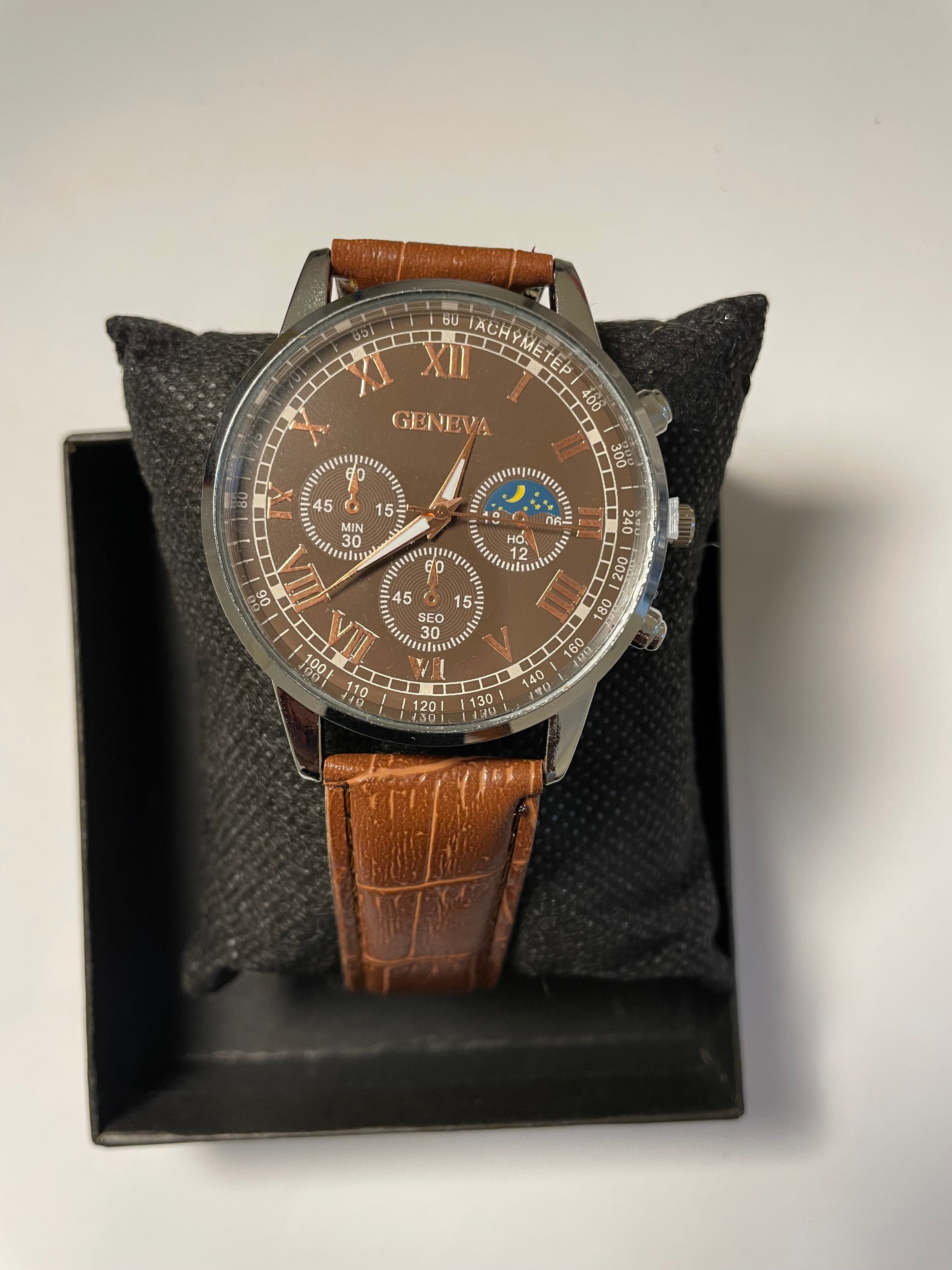 brown leather watch with moon phase