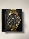 Black and gold watch with red accents